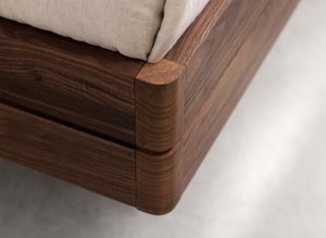 float wood bed with rounded corners in walnut